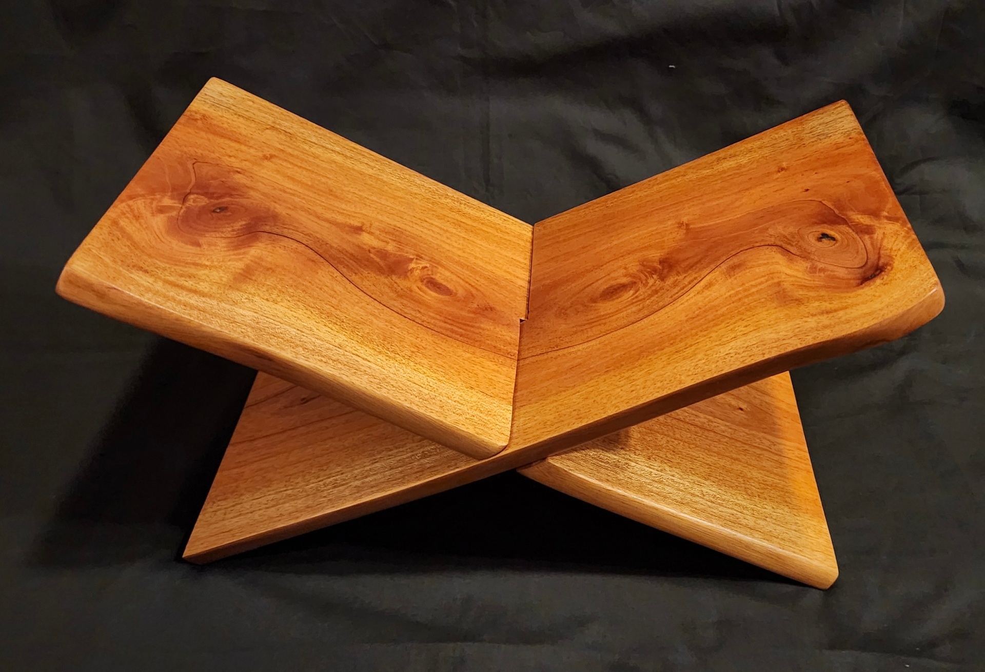 Sculptural X-form wooden book stand