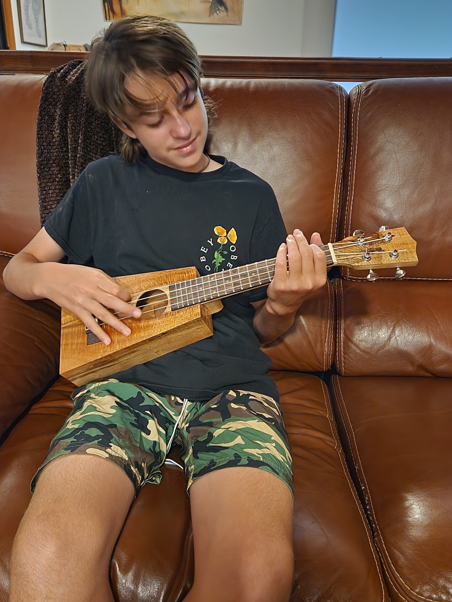 Trapezoidal koa ukulele being played